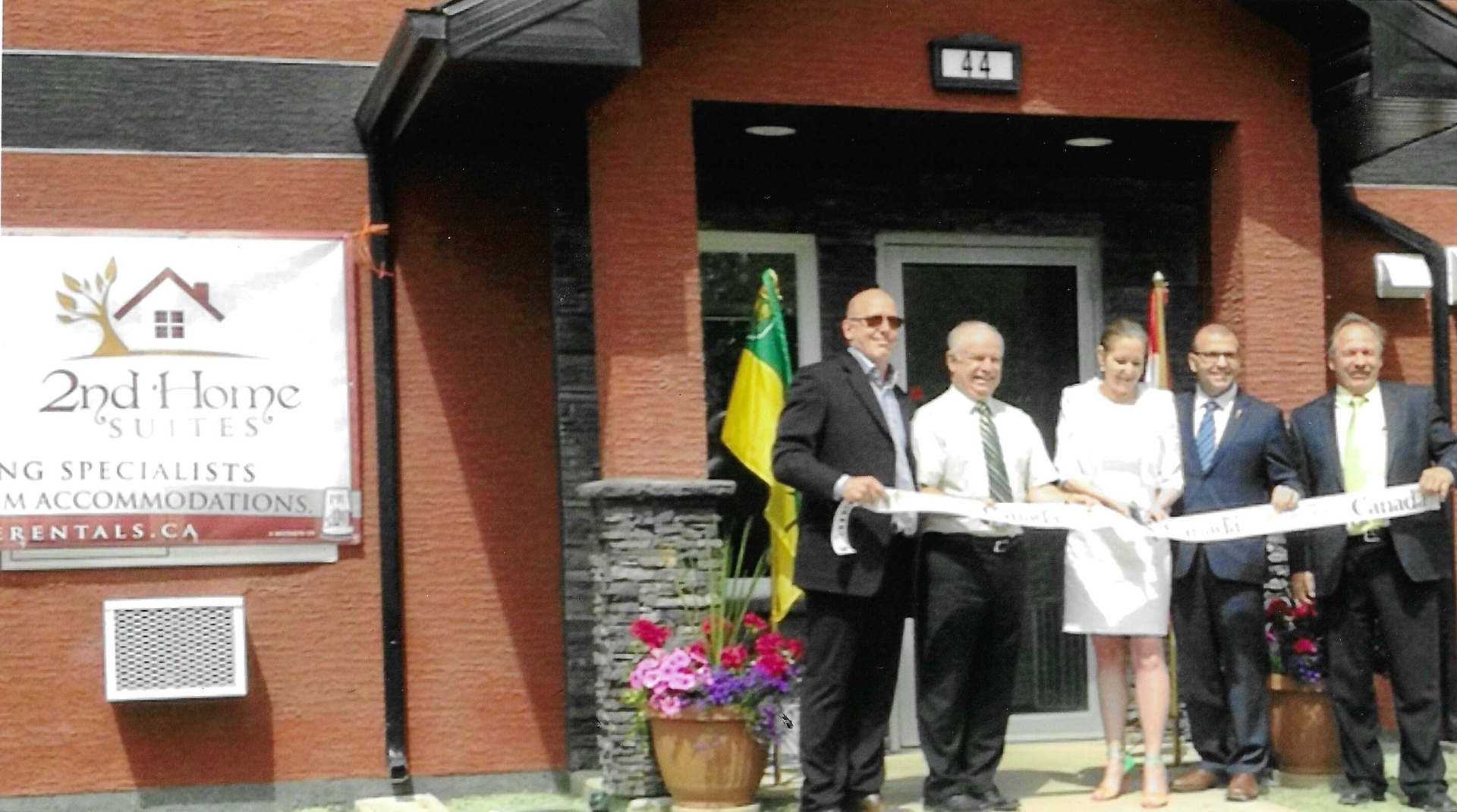 Ribbon cutting ceremony for 2nd Home Suites grand opening with Wade and Tim Probe, Deputy Minister Leanne Dagenais, and Mayor Bob Maloney